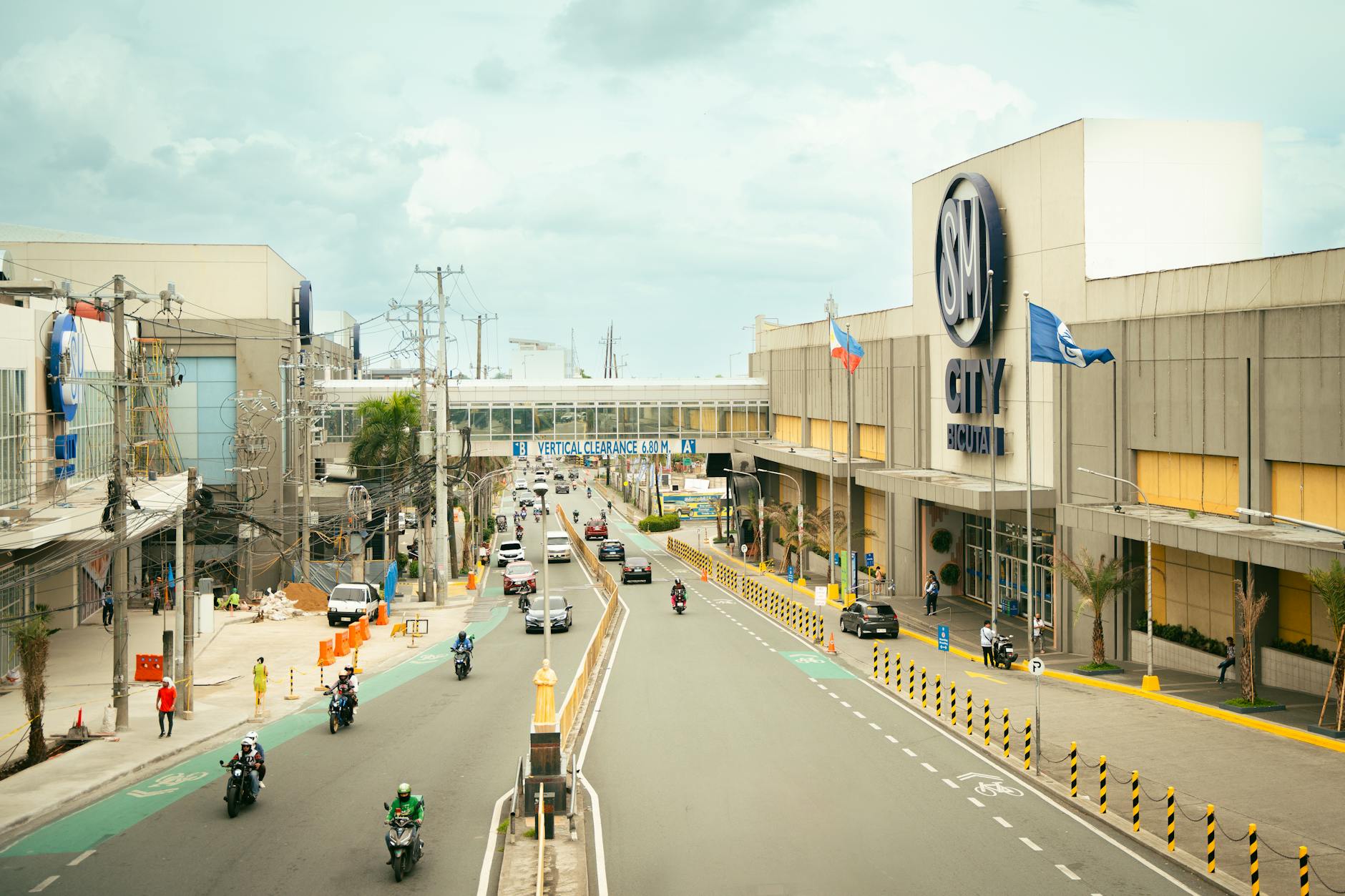 a city street with cars and motorcycles on it