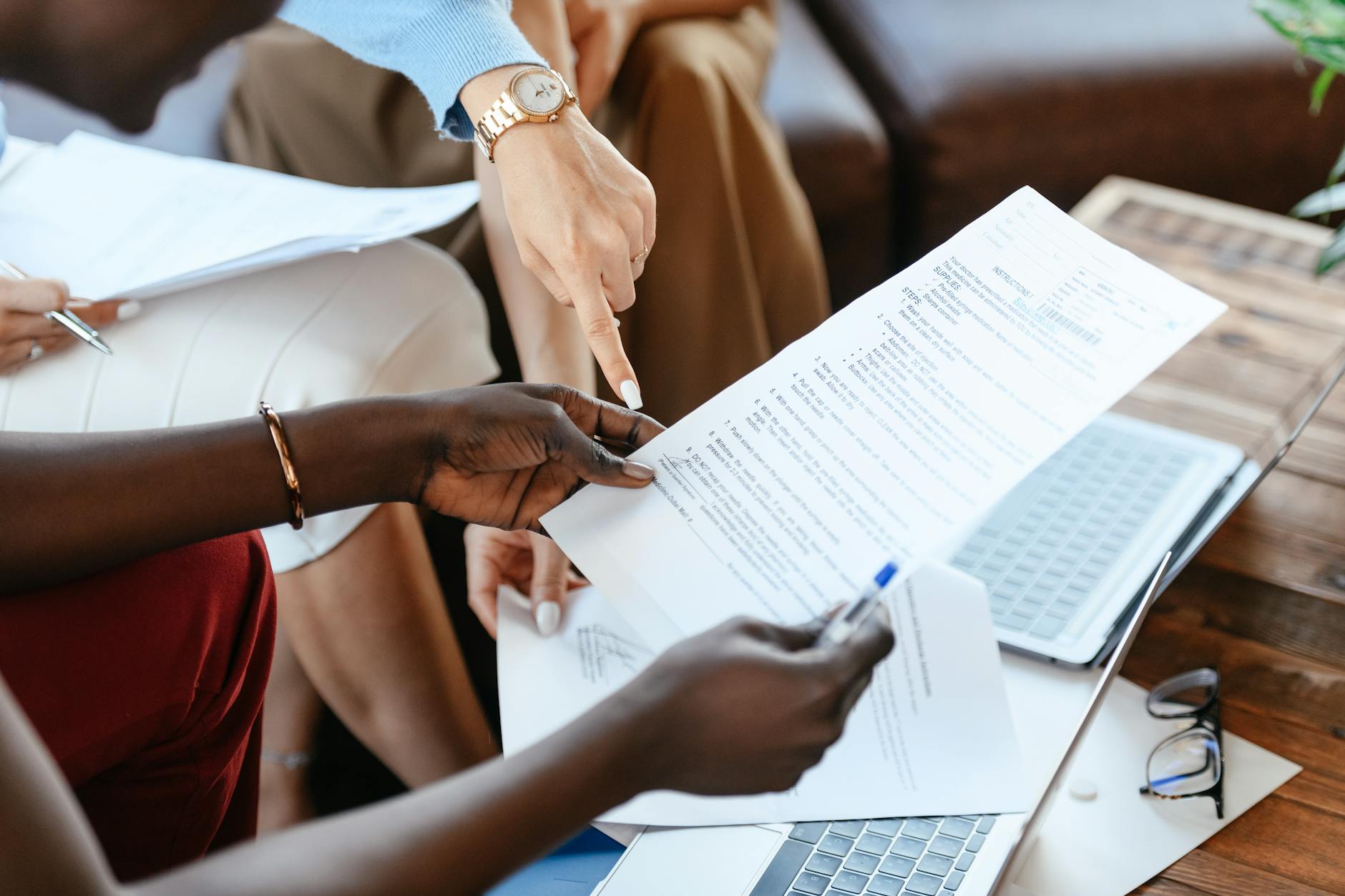 multiethnic businesswomen checking information in documents